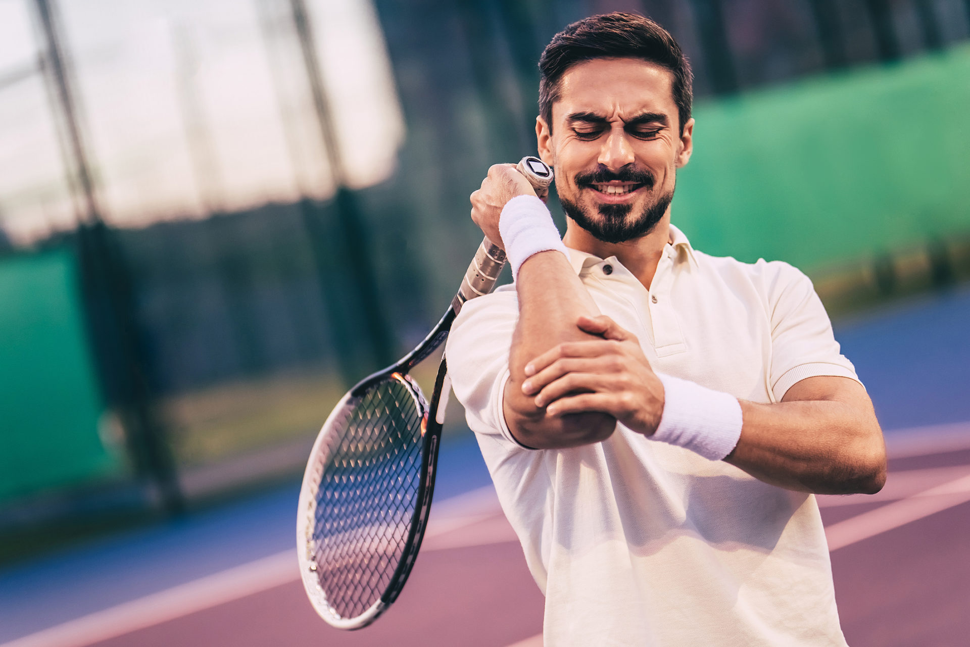 Man experiencing pain and discomfrot due to Tennis Elbow